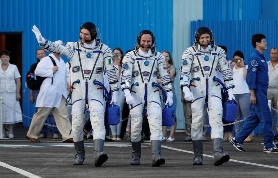 Three astro<em></em>nauts reach space station with Russian space caps Three astro<em></em>nauts reach space station with Russian space caps
